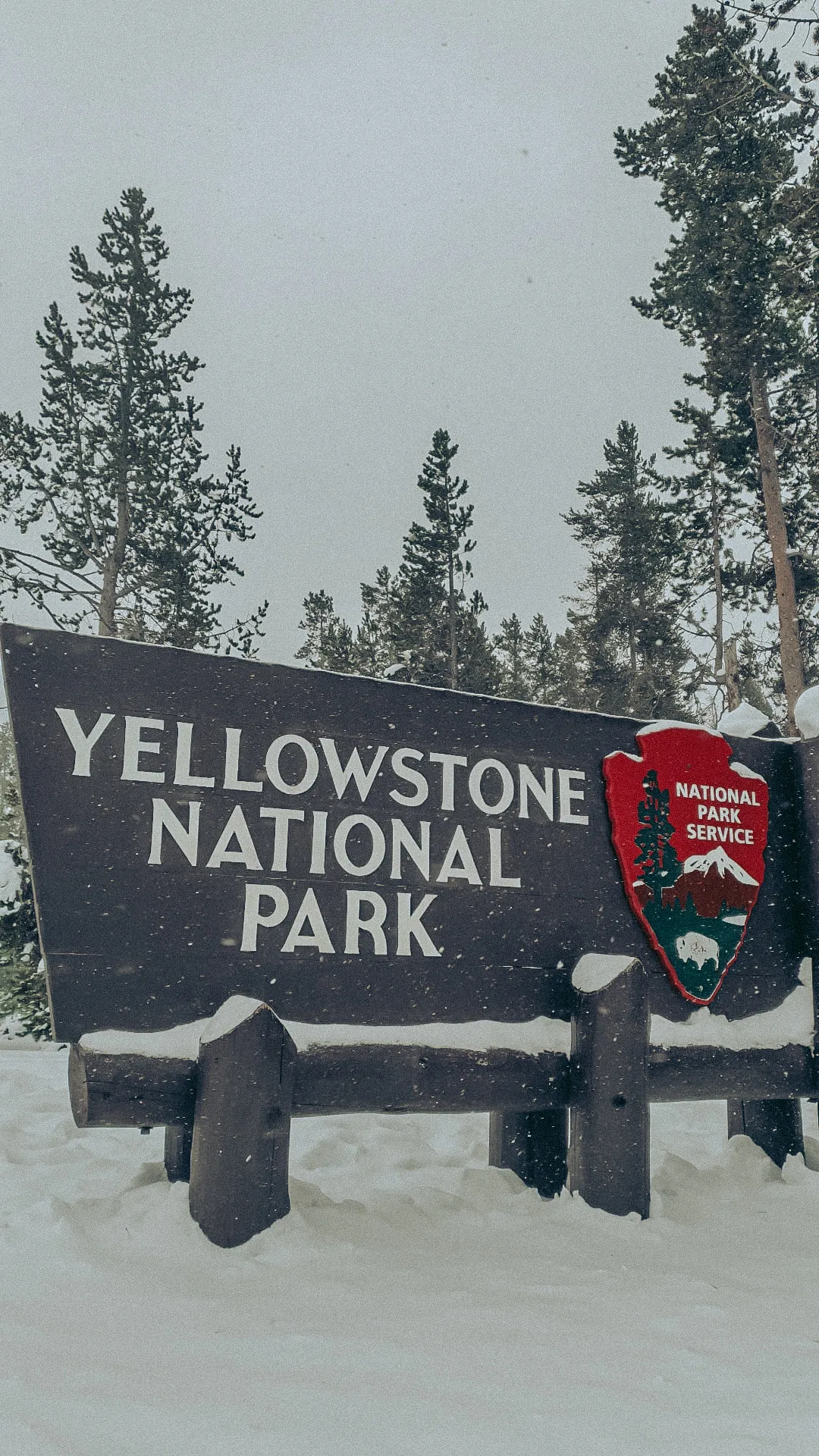 Yellowstone park entrance sign in winter